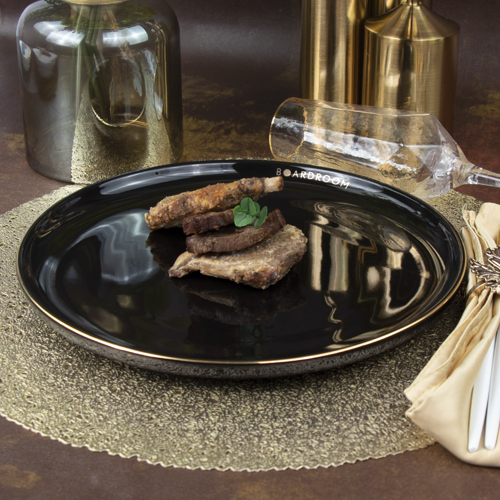 Assiette de restaurant noire en céramique avec bord doré 